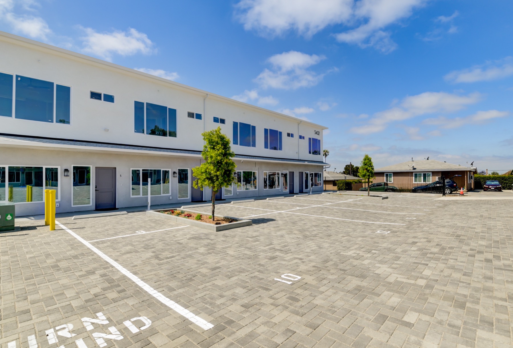 Kyra at Churchward exterior and parking court in San Diego