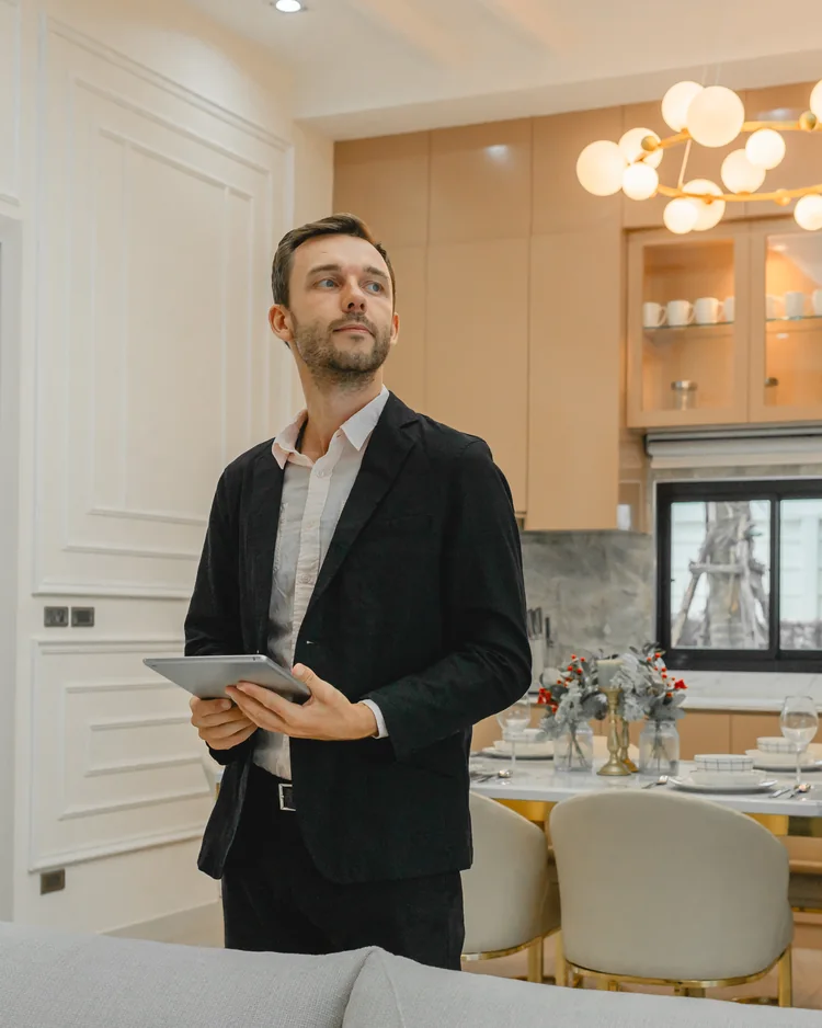 Person holding a tablet inside a modern home