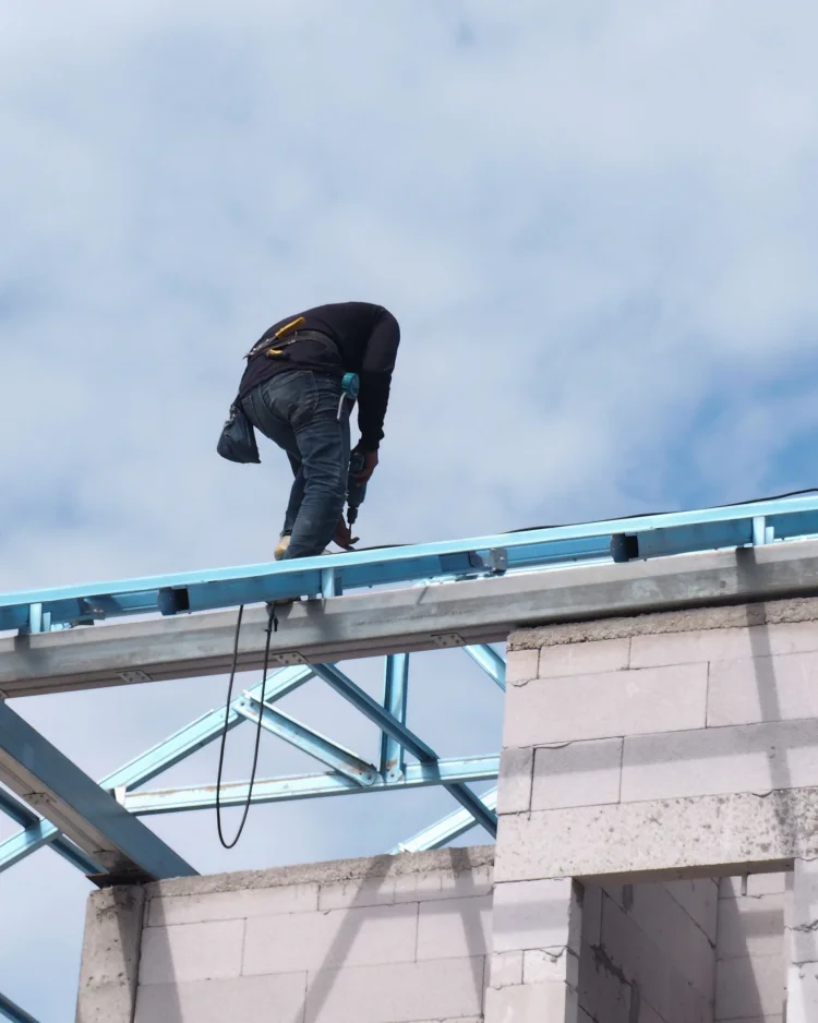 Contractor working on the roof frame of a residential structure