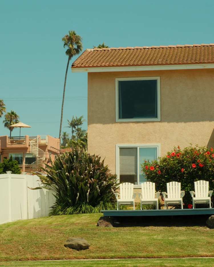 Daytime view of a San Diego residential home with palm trees and blue sky