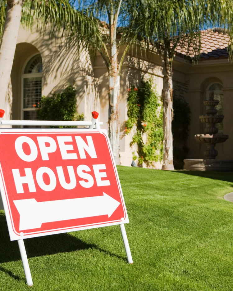 Residential home with an open house sign for a property-specific buyer review