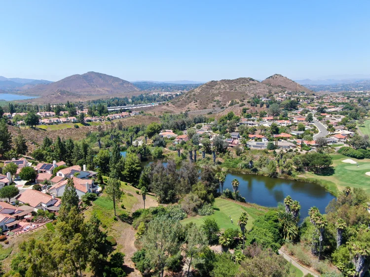 Tile-roof homes beside landscaped open space and hills in Rancho Bernardo, San Diego.