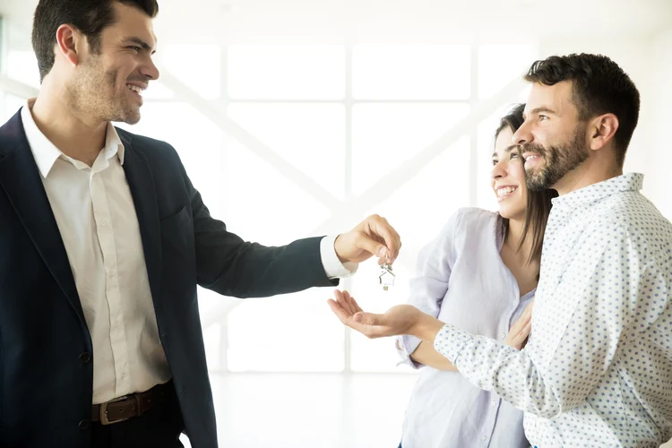 A couple receiving keys during a home transaction